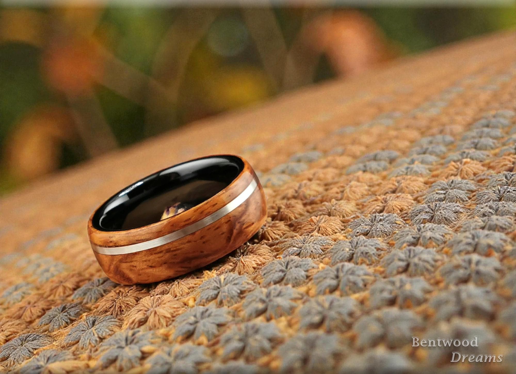 Bentwood Ring: Quilted Afzelia, offset inlaid Sterling Silver, Polished Black Ceramic core, wood ring